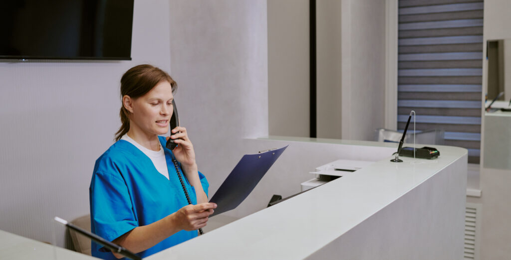 Dental Receptionist Answering The Phone