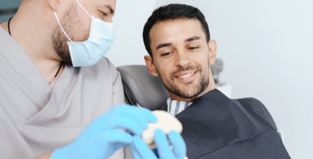 Dentist explaining dental implant healing and recovery to a patient