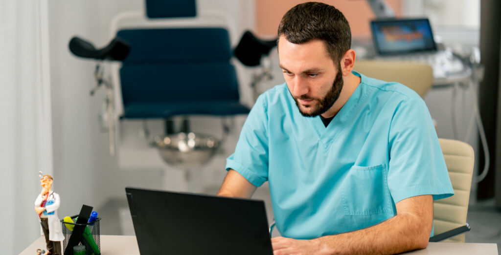 Dentist Filling Out Referral Form Online