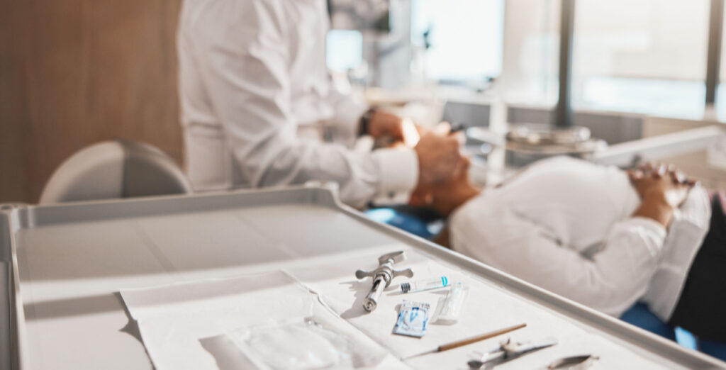 Dental professional performing a tooth extraction during oral surgery