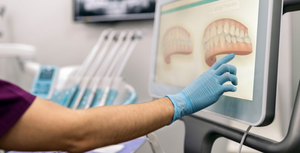 Dental professional reviewing digital treatment planning for oral surgery
