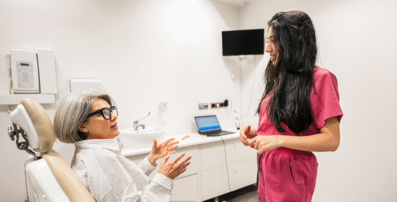 Dental professional discussing oral surgery treatment with a patient