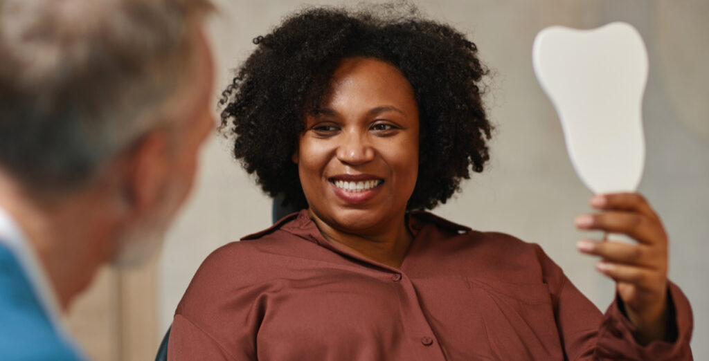Smiling patient after dental implant treatment to restore missing teeth