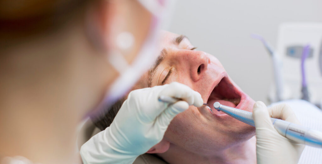 Male patient receiving wisdom teeth removal care during an oral surgery visit