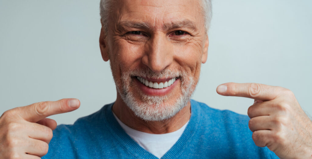 Man Pointing To Dental Implants