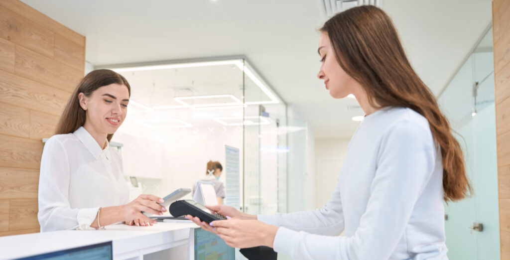 Female patient reviewing payment options for oral surgery treatment